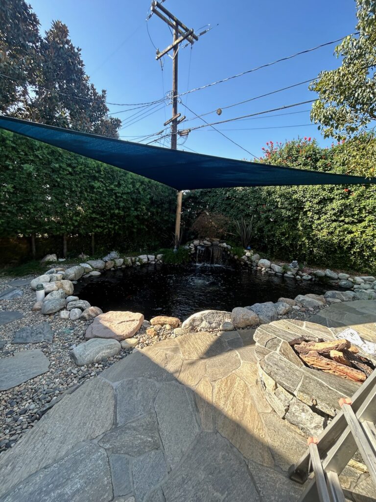 blue shade sail over pool